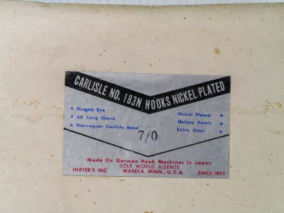 Carlisle No. 183N hook packaging label by Herter's Inc — offset-printed chrome-coated card showing specifications and manufacturing claims — size 7/0 — nickel-plated finish