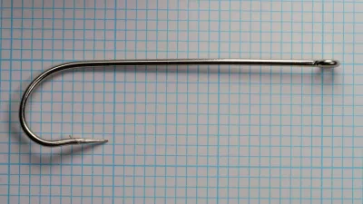Carlisle 183N hook full length — profile view showing 6X-long shank, ringed eye, and overall proportions — size 7/0 — nickel-plated finish on measurement grid