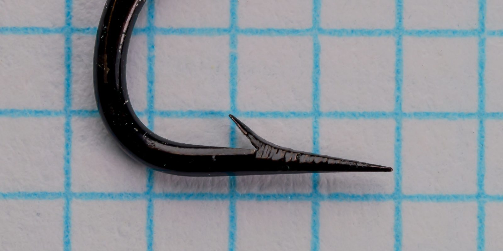 Herter's 3718 Salmon Fly Hook — close-up of point and barb geometry from side profile — size No. 4 — hollow point with japanned finish