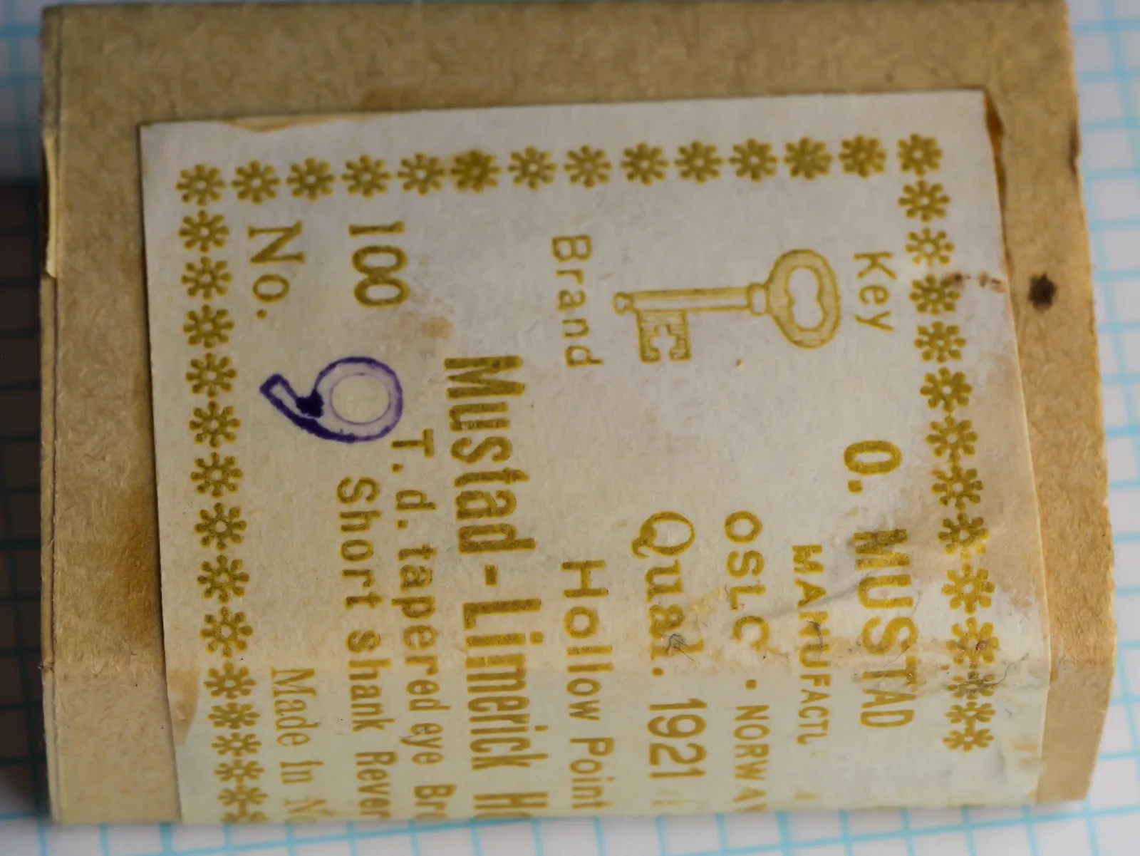 Paper-wrapped packet with a cream printed label, turned a quarter turn