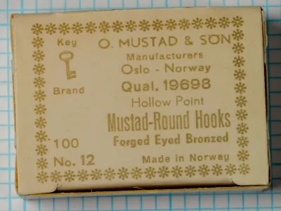 Mustad 19698 Key Brand Original Box — vintage packaging showing gold snowflake border design — size 12 — cream cardboard with letterpress printing