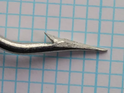 Mustad 3138 hook — superior point detail on measurement grid — size 9/0 — showing barb and point geometry