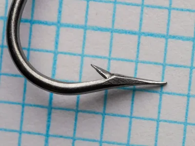 Mustad 3306 hook point detail — spear point geometry and keeper barb — size 18 — bright steel finish