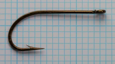 Mustad 3811 O'Shaughnessy Hook — full profile view showing complete hook geometry including eye, shank, bend, and point — size 3/0