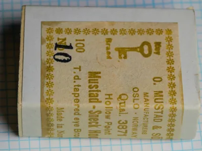 Mustad 3871 Size 10 — sealed box showing reverse side with rotated label text and additional manufacturing information