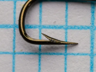 Mustad 3871 Size 10 — single hook profile showing Sneck bend, hollow point, and tapered eye on measurement grid