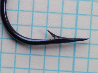 Mustad 38928 Sproat Hook — profile view showing point geometry — size 4/0 — hollow point with concave inner face and rapid flare to barb