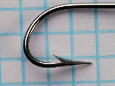 Mustad 4370 Size 10 Hook — side profile showing point detail, Kirby offset, and ringed eye — bright steel finish on measurement grid