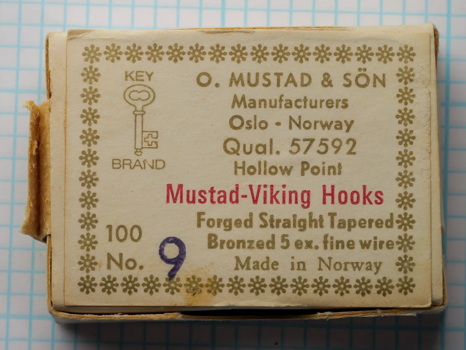 Mustad 57592 Viking Hooks — original sales card front label — size No. 9 — showing eight-line label format with Oslo origin and blind eye specification, bronzed finish, photographed on measurement grid