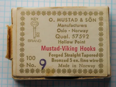 Mustad 57592 Viking Hooks — original sales card front label — size No. 9 — showing eight-line label format with Oslo origin and blind eye specification, bronzed finish, photographed on measurement grid