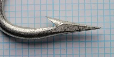 Mustad 722 Hook Point — lateral profile showing bend geometry and point structure — size 17/0 — tinned finish