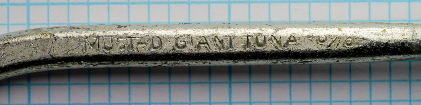 Mustad 7734 Giant Tuna Hook — shank engraving detail showing model marking — size 10/0 — tinned finish with forging marks