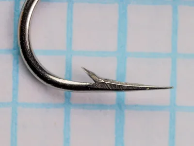 Mustad 7925 — close-up of hook point — size 10 — hollow-point geometry showing concave inner face