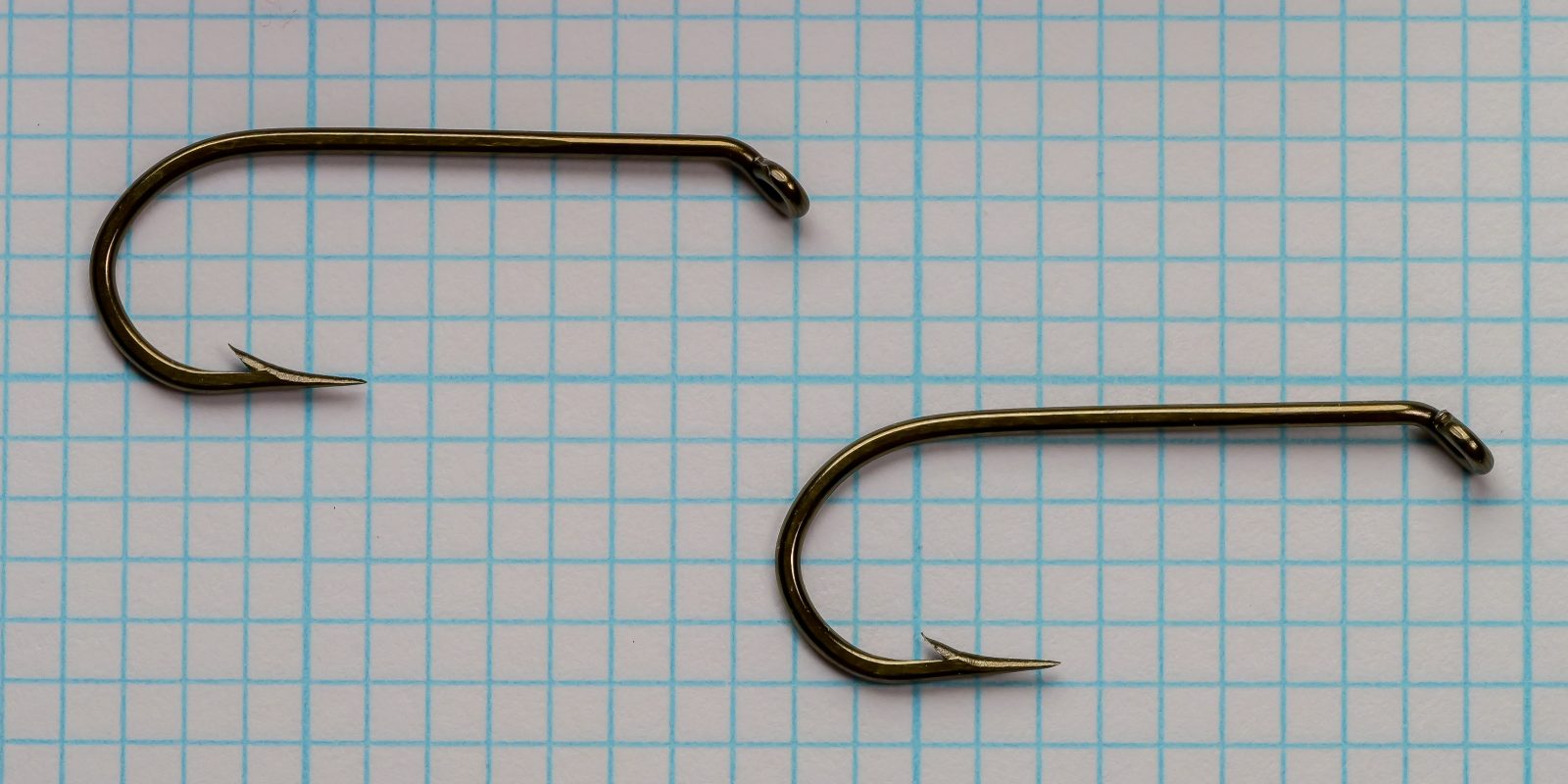 Mustad 7957 BX — two specimens shown for comparison of bend depth and shank proportions — bronzed — size No. 2