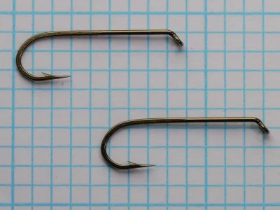 Mustad 79580 Hooks — two size 14 specimens shown for comparison, displaying hook consistency — bronzed finish — measurement grid background