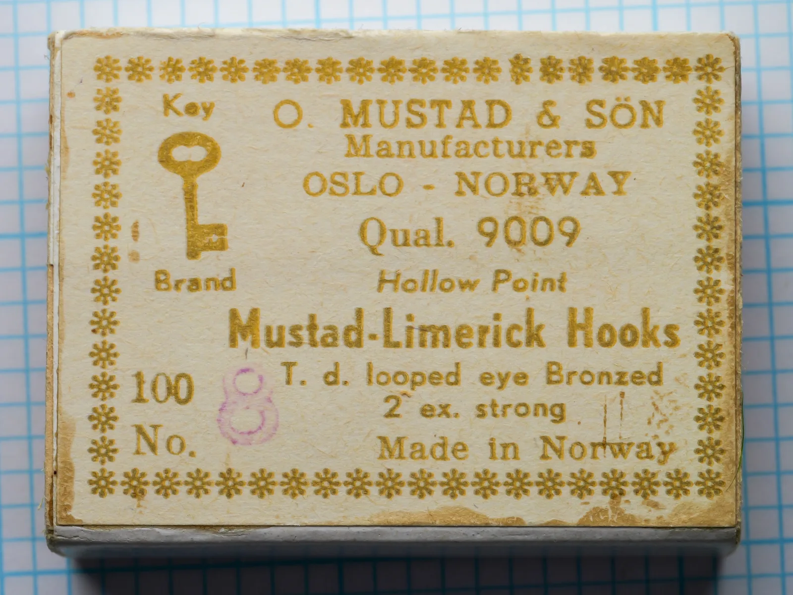 Mustad 9009 Size 8 Limerick Hooks — original sales card with gold foil letterpress label, Key Brand logo, and complete package of 100 bronzed hooks intact — showing eight-line Mustad label format and gold decorative border