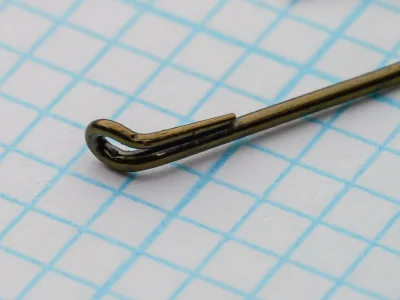 Mustad 9009 Size 8 — close-up detail of the turned-down tapered looped eye — showing the return wire running parallel down the shank and the elegant taper of the terminal loop
