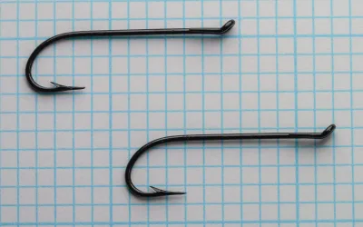 Mustad 9049 — two size 6 hooks photographed together — showing hook proportions and Limerick bend profile — japanned black finish