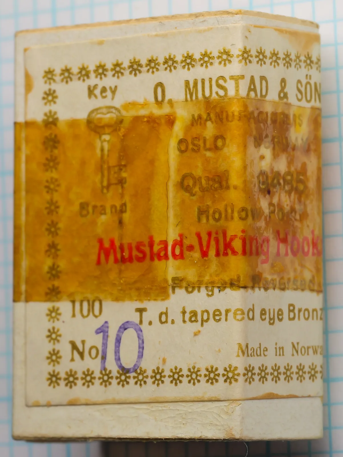 Mustad 9485 size 10 box upright, with key device, Qual. 9485 and a purple 10 on the label.