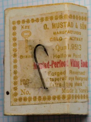 Mustad 9513 vintage hook, size 10 — side profile showing extra-long shank, Viking bend geometry, and tapered eye on measurement grid