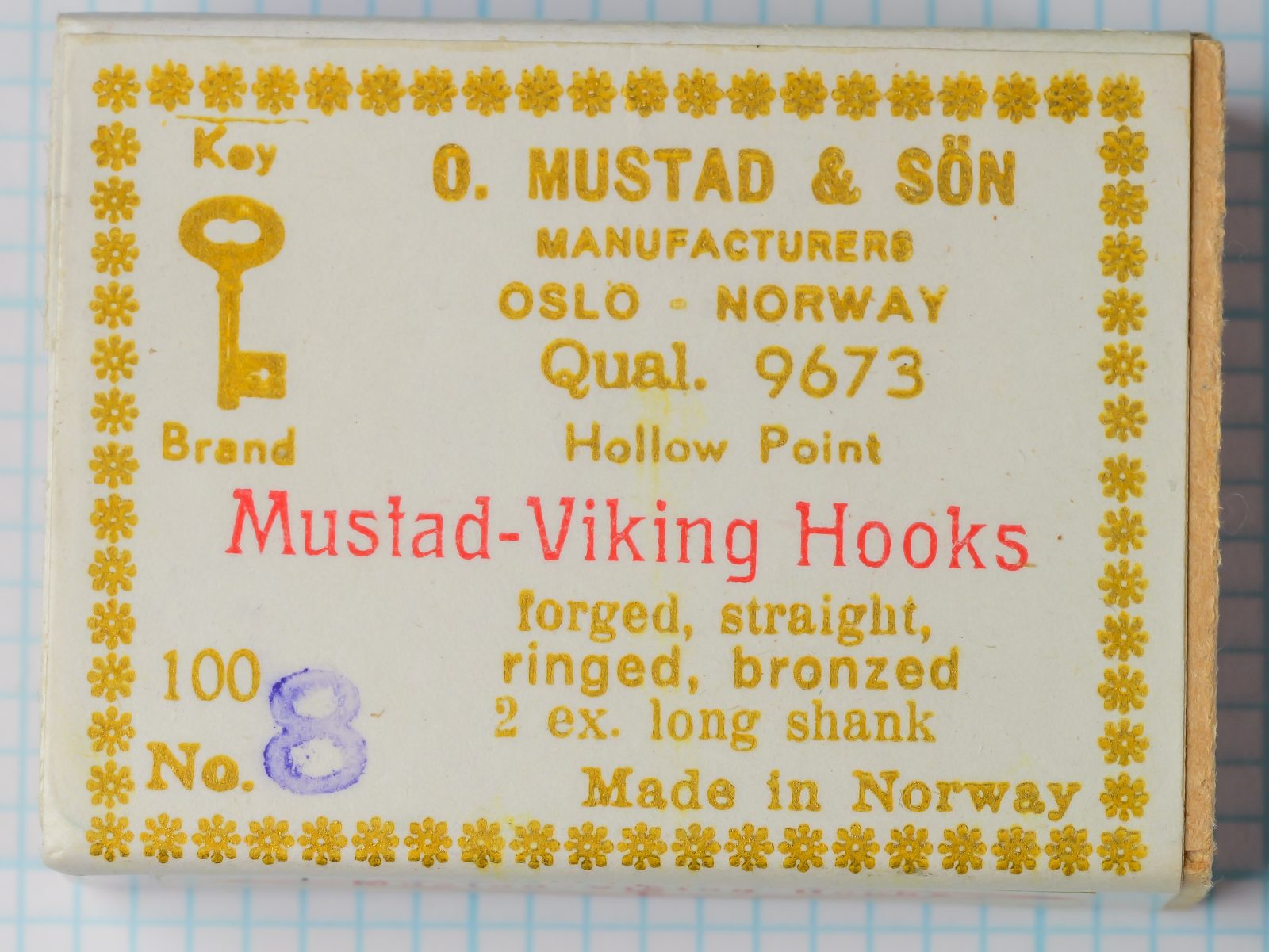 Mustad 9673 Size 8 — packaging front with label — hand-stamped purple size numeral and gold-foil border