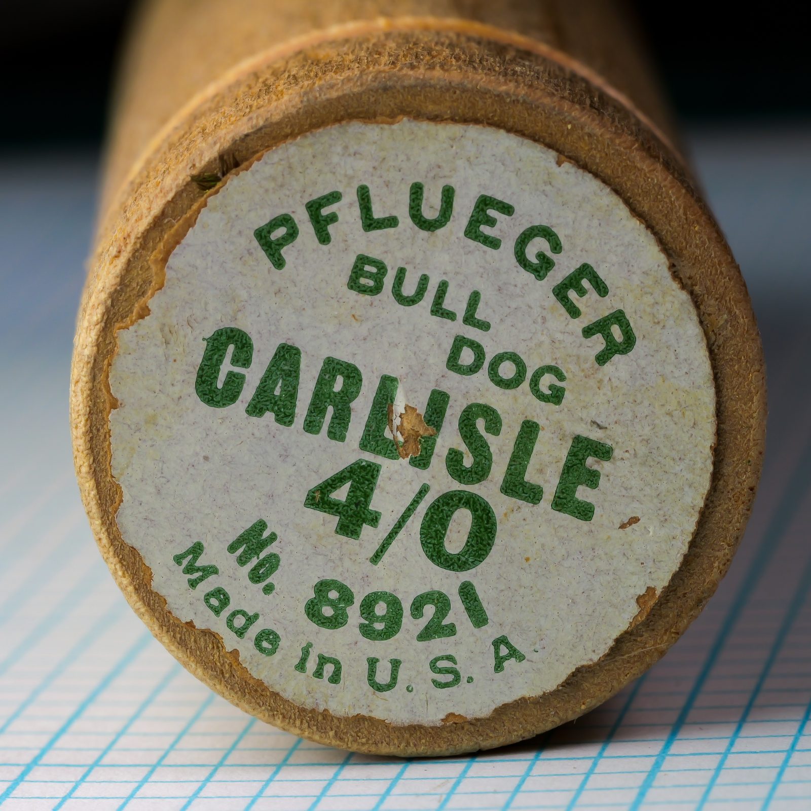 Pflueger wooden tube packaging — printed label end cap — showing model number 8921, Carlisle, size 4/0, Made in USA