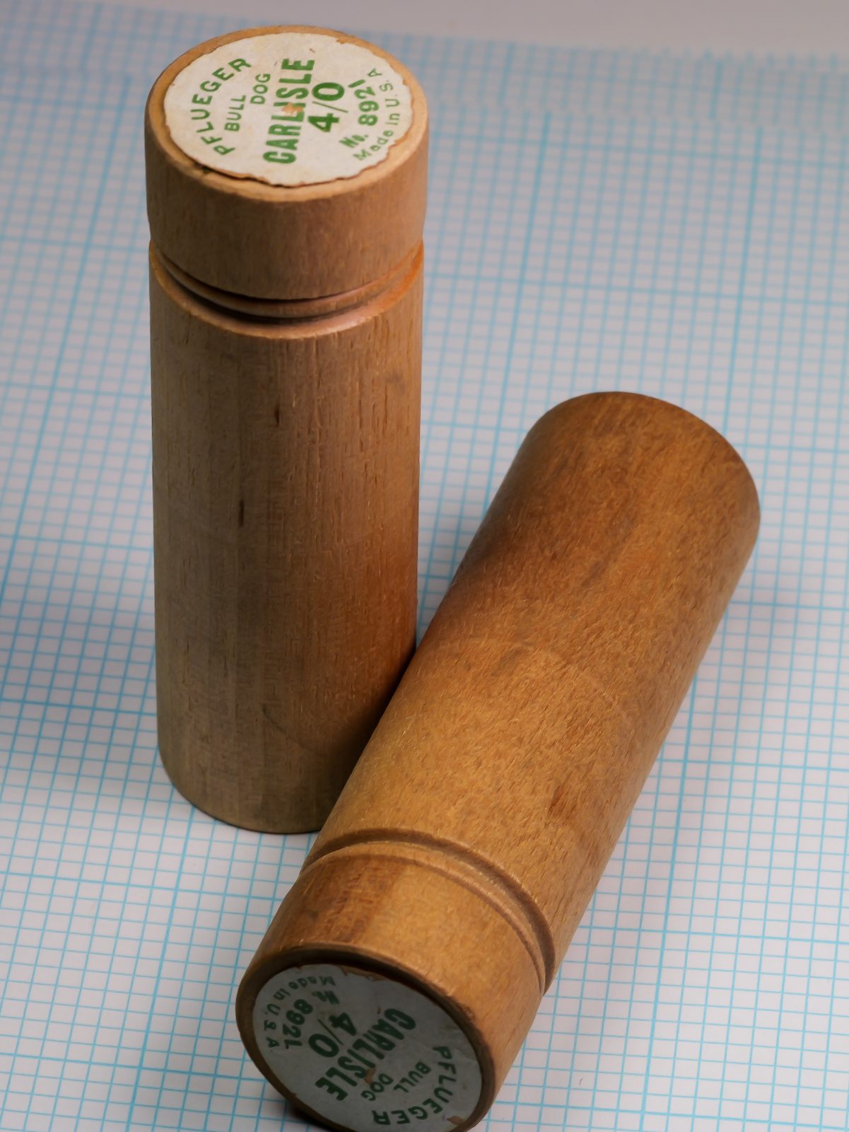 Pflueger wooden tube packaging — full tube and end cap assembly — showing natural wood construction and label positioning