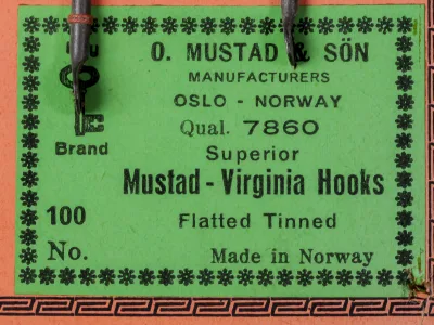 Mustad 7860 sales card label detail — showing manufacturer information, model code, product line, and finish specifications in eight-line format