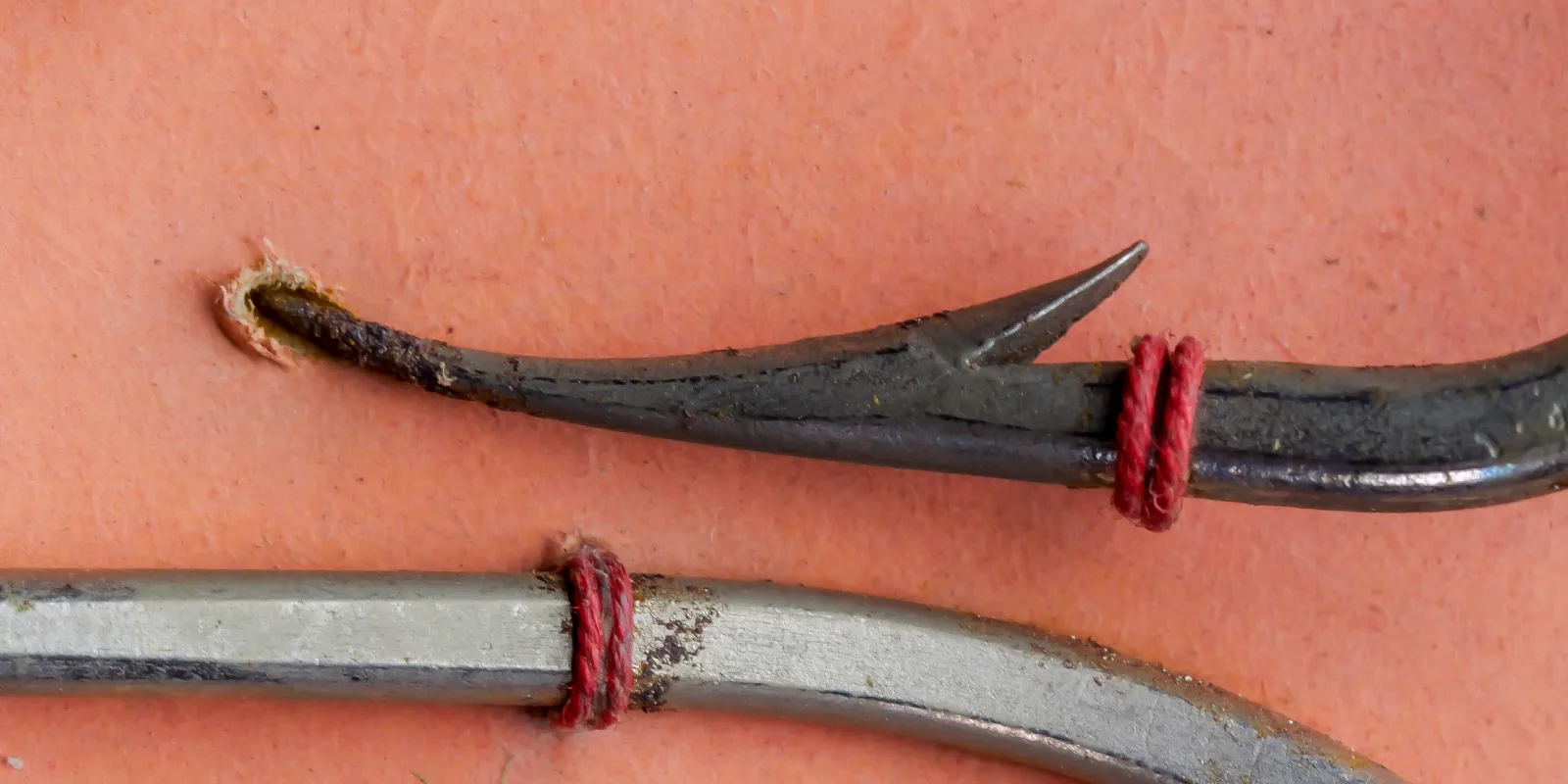 Mustad 92600 Beak Hook — close-up of point geometry showing hollow point and barb — size 4/0 specimen — reversed offset detail on measurement grid