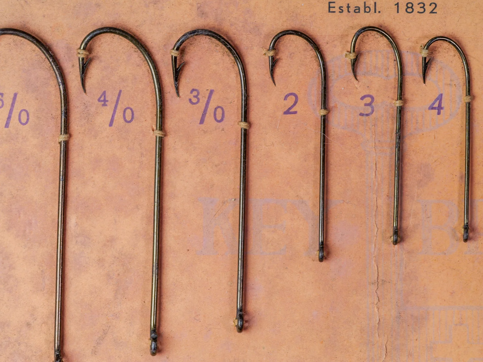 Left and center of a Mustad 93400 sales card with large mounted Carlisle hook samples.