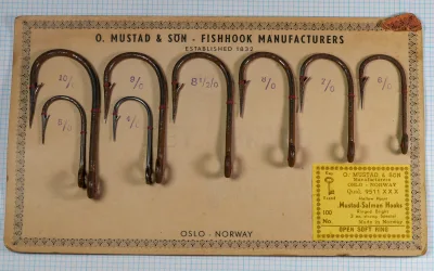 Mustad 9511 XXX salesman sample card — complete eight-hook display with cream and yellow stock showing Oslo-made origin and Key Brand logo, sizes 4/0 through 10/0 including rare 8½/0, photographed on 1/10-inch measurement grid.