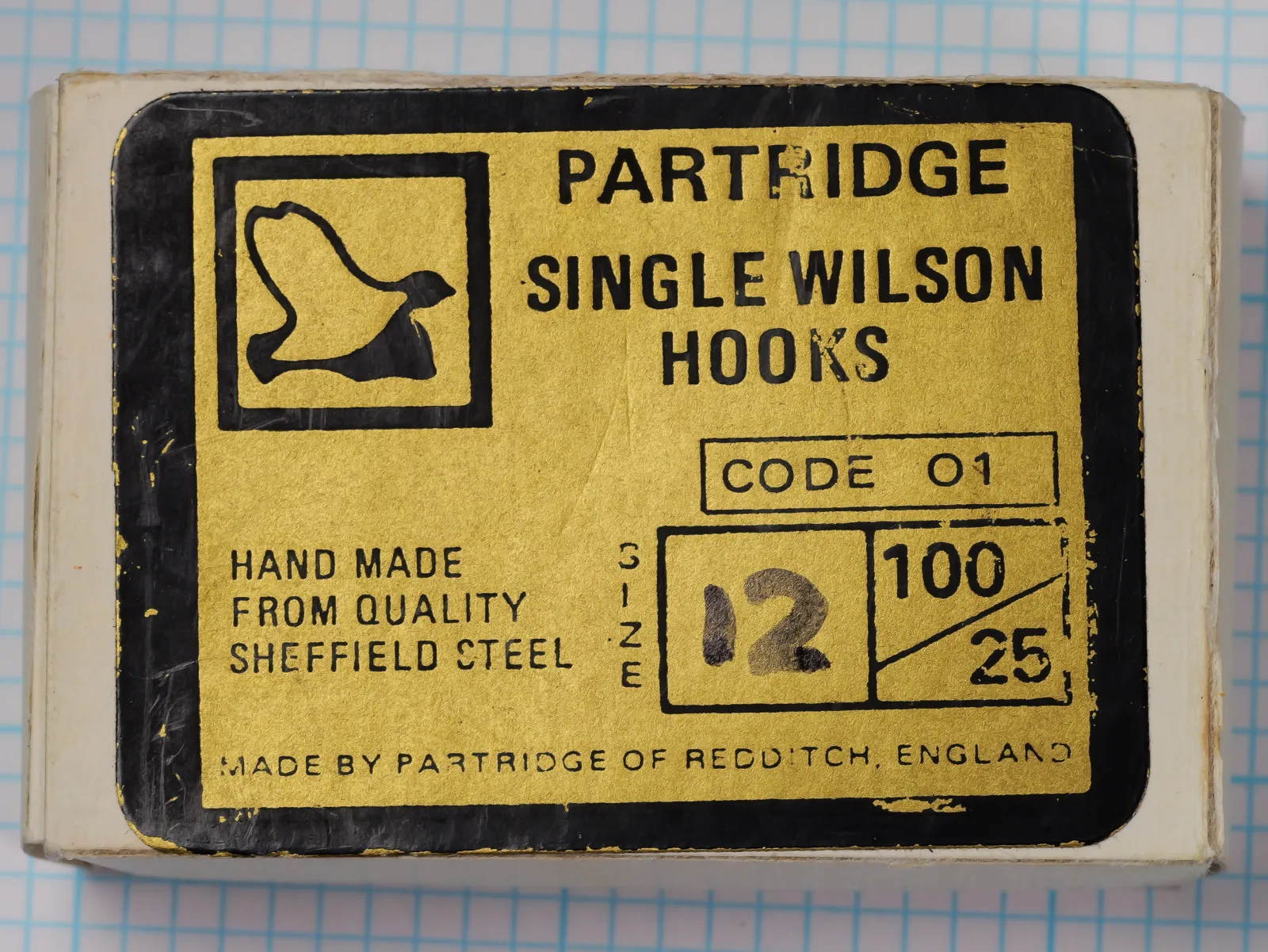 Partridge Single Wilson Hooks box, Code 01, size 12, with a rounded gold label in a wide black border.
