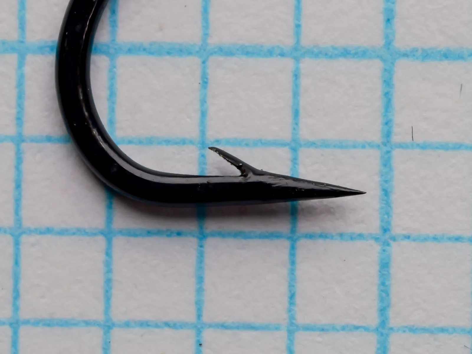 Partridge CS2 S.E.B. Steelhead/Salmon Hook — side profile showing point and barb detail — size No. 4 — japanned black finish on measurement grid