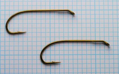 Partridge CS42 Hooks — two specimens side by side — Size 2 — bronzed finish on measurement grid
