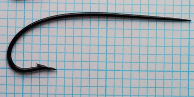 Partridge CS10/3 — two hooks size 3/0 on measurement grid — profile view showing full bend and shank — japanned finish