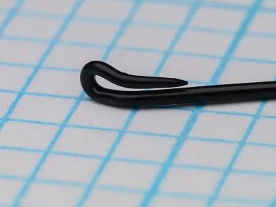 Partridge CS2 BL Size 10 — close-up of hook eye showing straight-tapered up-eye and bright black blued finish — on 1/10-inch measurement grid