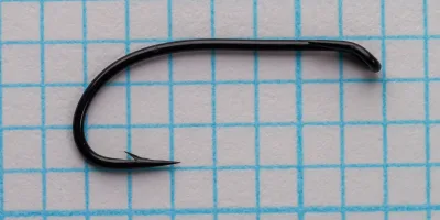 Partridge CS2 BL Size 10 — full profile showing long 2X shank, robust forged wire, and black blued finish — on 1/10-inch measurement grid