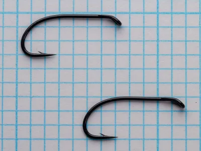 Partridge CS2 BL Size 10 — pair of hooks showing consistency of bend geometry, wire gauge, and finish across batch production — on 1/10-inch measurement grid