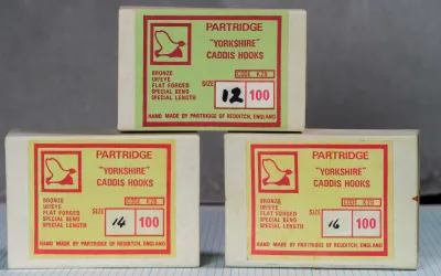 Partridge K2B Yorkshire Caddis Hooks — three unopened boxes in sizes 12, 14, and 16 showing label variations and original packaging condition