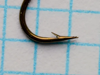 Partridge K2B Hook point detail — close-up of hook tip showing superior point geometry and barb angle on measurement grid