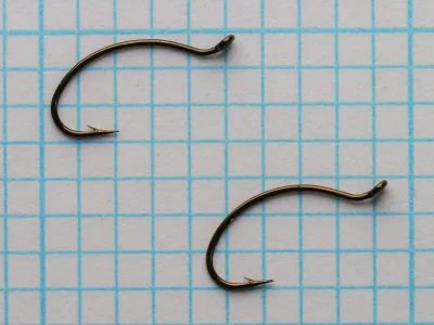 Partridge K2B Hooks — two specimens side-by-side on measurement grid showing consistency and fine wire gauge