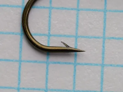 Partridge L2A size 1/0 wet fly hook, bronzed finish, side profile showing bend and point.