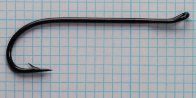 Blued salmon hook curved profile with eye detail on grid pattern