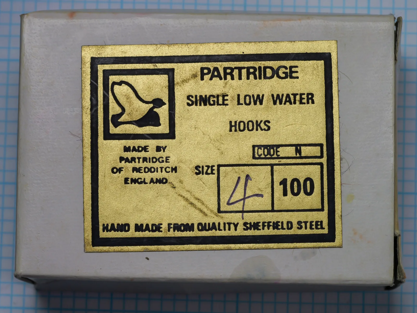 Partridge Code N Single Low Water — yellow and black label on cardboard box — size 1/0 — hand-marked notation visible
