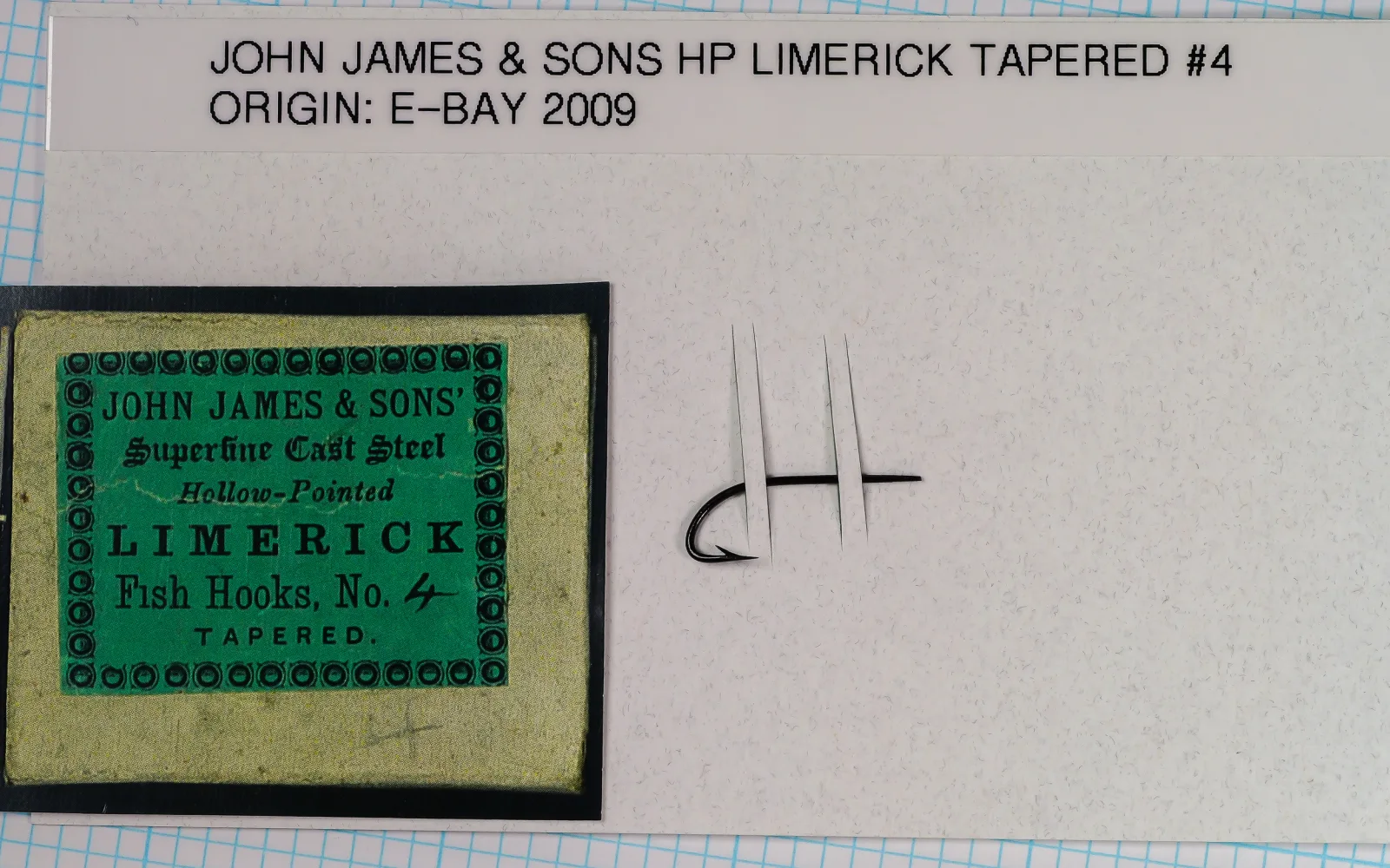 White collector card with a label strip reading JOHN JAMES & SONS HP LIMERICK TAPERED #4, ORIGIN: E-BAY 2009, the green label print at left and the hook threaded through two slits at right.