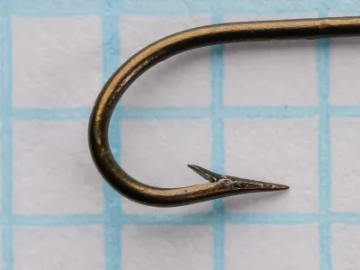 Mustad 3202 Carlisle hook side view showing long curved bend and barbed point