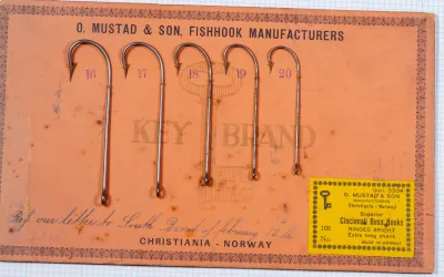 Mustad 3304 specimen card — full view — handwritten South Bend reference — orange backing paper
