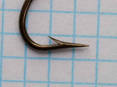 Mustad 3451 Kinsey Hook — side profile showing pointed end and barb geometry — estimated size 1/0 — Superior point