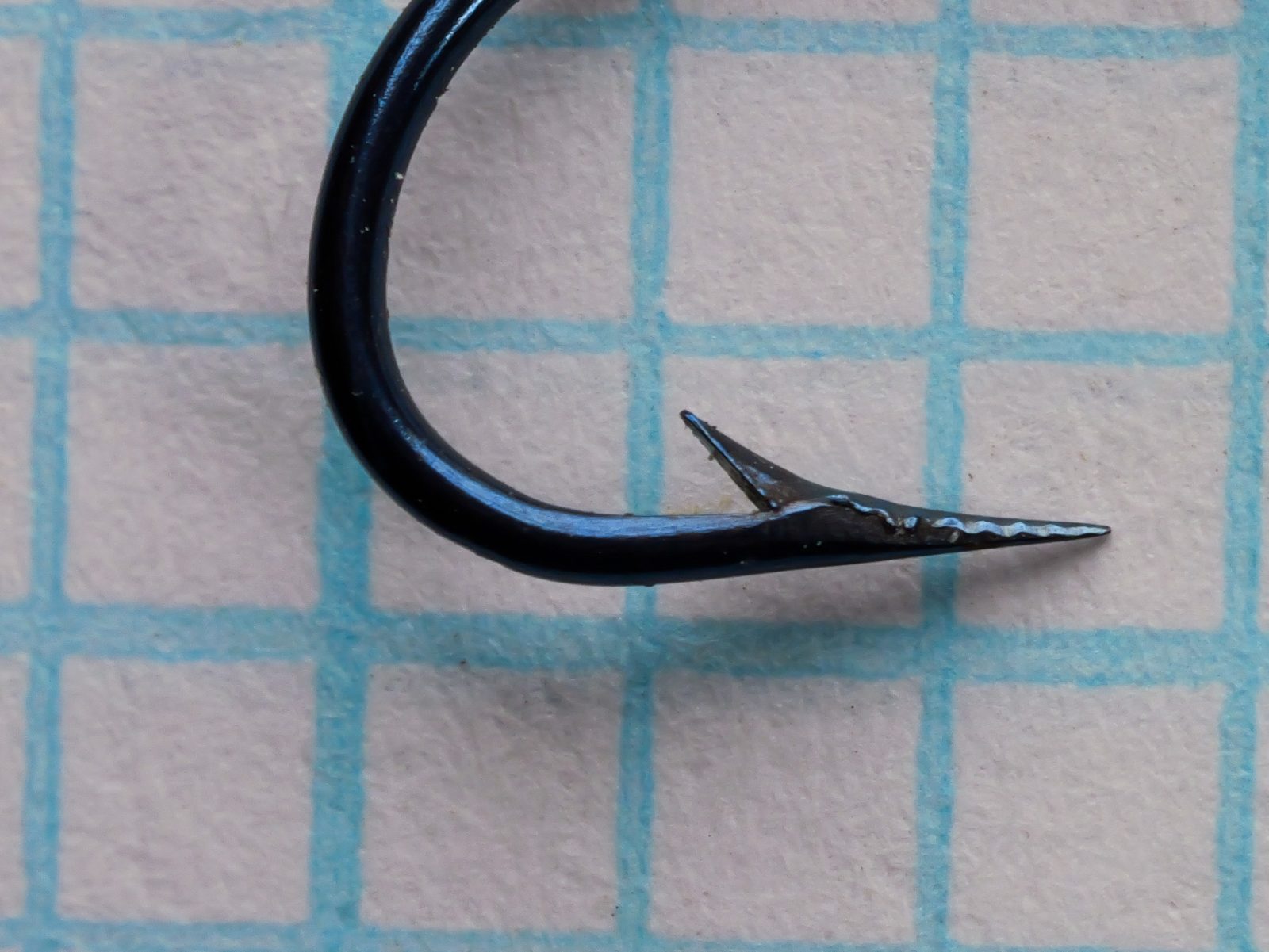 Mustad 3705 Carlisle Hook — angled side-view showing marked shank, hollow point geometry, and blind eye — size 8 — blued finish on 1/10-inch grid