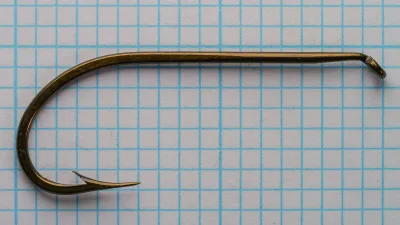 Mustad 3822 O'Shaughnessy Hook — full profile and bend shape on measurement grid — size 1/0 — forged shank visible
